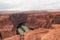 Horseshoe Bend - Tourist man with panoramic aerial view of Horseshoe bend on the Colorado river near Page in summer, Arizona, USA