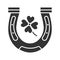 Horseshoe and four leaf clover glyph icon