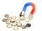 Horseshoe magnet attracts euro coins - investment concept