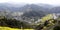 Horseshoe and u-shaped river in the mountains, the village and yellow rape, on opposite sides of the river