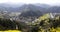 Horseshoe and u-shaped river in the mountains, the village and yellow rape, on opposite sides of the river