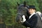 Horsewoman jockey in uniform with horse