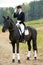 Horsewoman jockey in uniform with horse