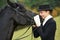 Horsewoman jockey in uniform with horse