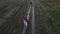 Horsewomen gallop on horseback along a dirt road