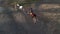 Horsewomen ride horseback in paddock