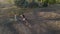 Horsewomen ride horseback in paddock