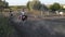 Horsewomen ride by trot horseback in paddock