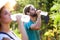 Horticulturist couple having a working break and drinking water in the garden.