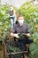 Horticulturists in medical masks harvesting cucumbers