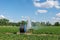 Hose Reel Irrigation Sprinkler Machine with Water Sprinkler set up on agricultural field.