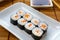 Hosomaki thin rolls, simple rolls, small rolls, with salmon. on a white plate. Syake Maki Classic roll with fresh salmon