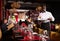 Hospitable african-american waiter standing with serving tray meeting restaurant guests