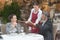 Hospitable waitress taking couples order in gastronomy restaurant