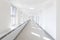 Hospital corridor bright light windows sun rays long white nobody