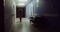 A hospital gurney left after urgent patient stands in hospital corridor