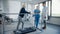 Hospital Physical Therapy: Strong Determined Senior Female Patient with Injury Walks on Treadmill