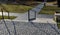 Hospital ramp disabled,made of concrete in the shape of round stones wooden staircase bench with staircase lighting with metal rai