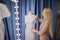 Hostess of the wedding salon looks at the wedding dress. Small business,