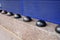 Hostile design steel half ball mounted front of building on the edge of the curb street