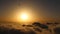 Hot air balloon above the clouds in sunrise