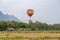 Hot air balloon above hut