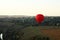 Hot air balloon (aerostat) over green fields
