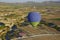 hot air balloon on the background of the terrain of mountains and fields and roads