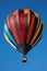 Hot air balloon, colorful aerostat on clear blue sky