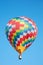 Hot air balloon, colorful checkered aerostat, blue sky