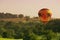 Hot Air Balloon Floats Above Rural Landscape