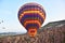 A Hot Air balloon floats over the Cappadocia landscape of Fairy Chimneys