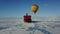 Hot air balloon flying above ice