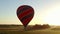 Hot air balloon flying in front of sun