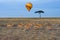 Hot air balloon flying over the african savannah. Kenya