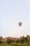 Hot air balloon flying over Cappadocia rocks, Turkey.