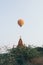 Hot air balloon flying over the pagoda at Bagan temple complex in Myanmar