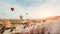 Hot air balloon flying over rock landscape at Cappadocia Turkey.