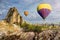 Hot air balloon flying over rock landscape at Cappadocia Turkey