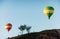 Hot air balloon flying over rock landscape at Cappadocia Turkey. Valley, ravine, hills, located between the volcanic