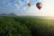Hot air balloon flying over tea plantation in morning
