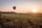 Hot air balloon lifts off over a farm field at sunrise, Pine Island, NY, early fall