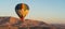 Hot air Balloon over Valley of the King in Luxor city in a morning, Upper Egypt. Panoramic banner portion