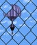 A hot air balloon is seen through a chain link