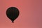 Hot Air Balloon Silhouette Flying In Red Sky At Morning