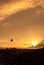 Hot air balloon silhouette at orange sunset