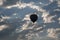 A hot air balloon silhouetted against the setting sun