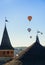 Hot air balloons above old castle