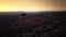 Hot air balloons with burning fire are levitating in sky over sandstone mountains at amazing dusk