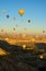 Hot air balloons festival in Cappadocia. Many colorful balloons against vibrant sky.